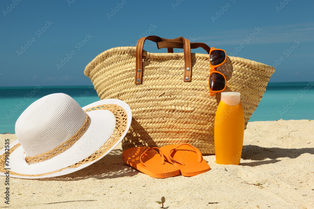 sun protection gear on the sand - obrazy, fototapety, plakaty 