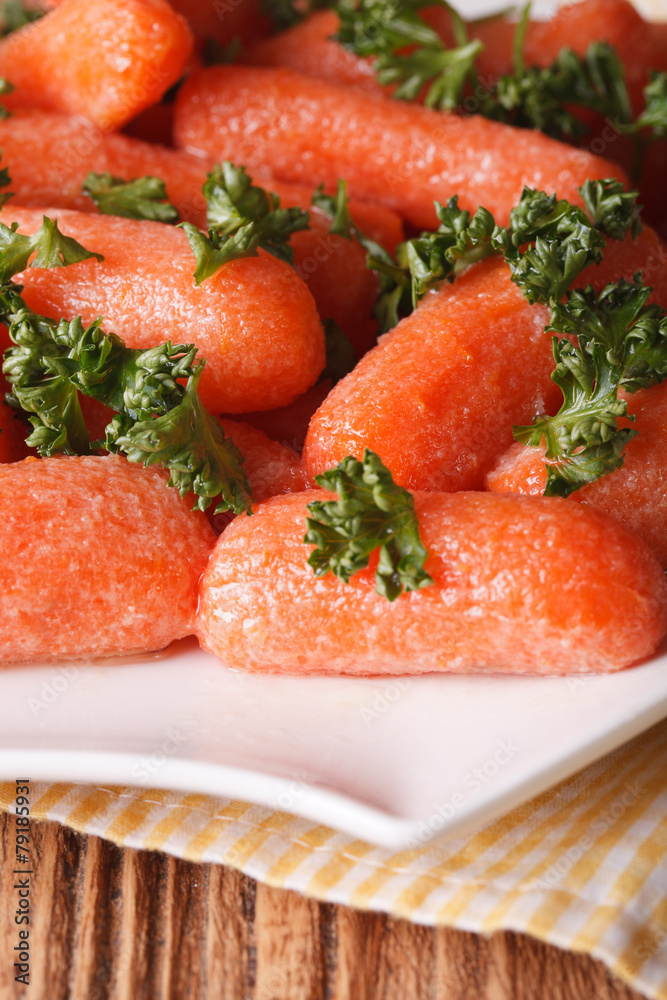 Glazed carrots with parsley on a white plate macro. vertical Glazed carrots with parsley on a white plate macro. vertical