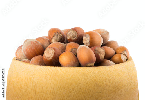 Hazelnut in a bowl isolated on white photo