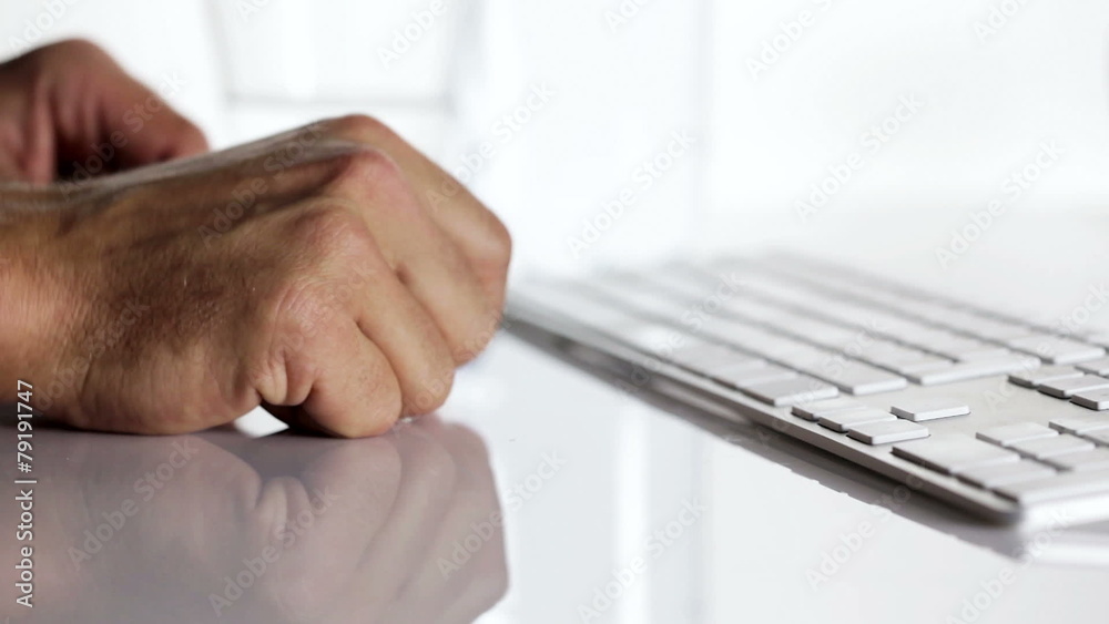 Office worker typing on a computer keyboard - taking some pills Office worker typing on a computer keyboard - taking some pills