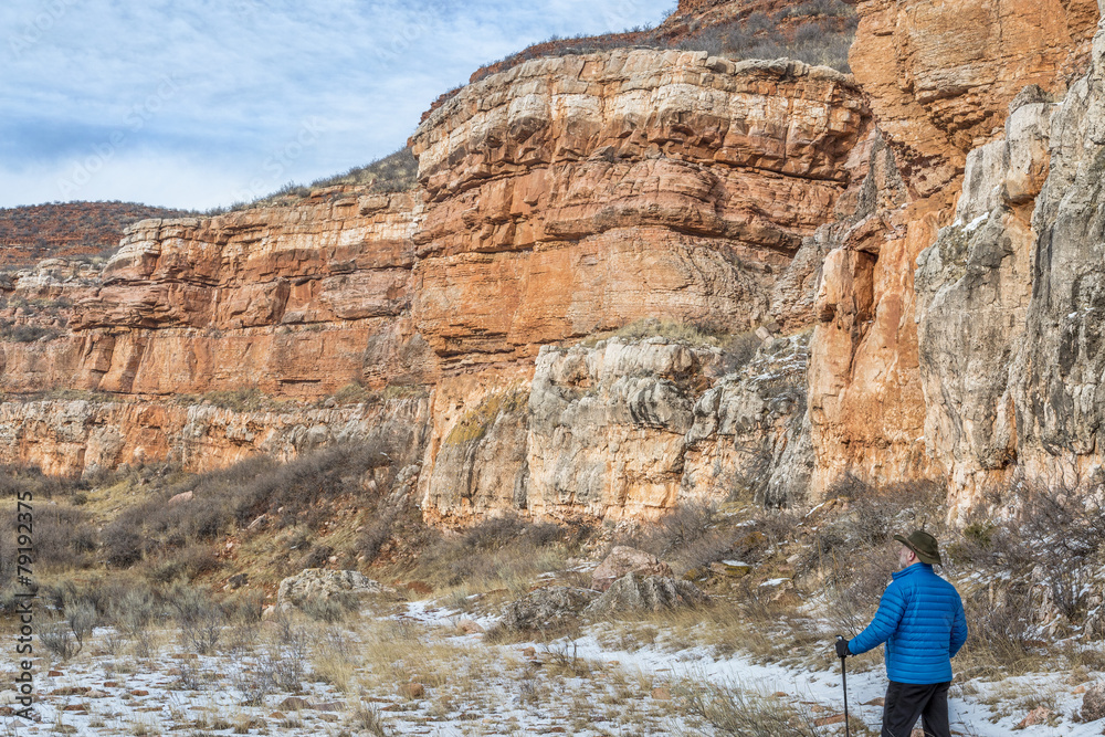 hiker in sandstone canyon