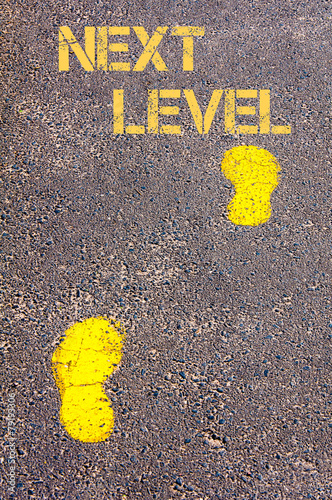 Obraz na płótnie Yellow footsteps on sidewalk towards Next Level message w salonie