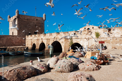 Fishing boats, gear and catch on background of Castelo Real of M