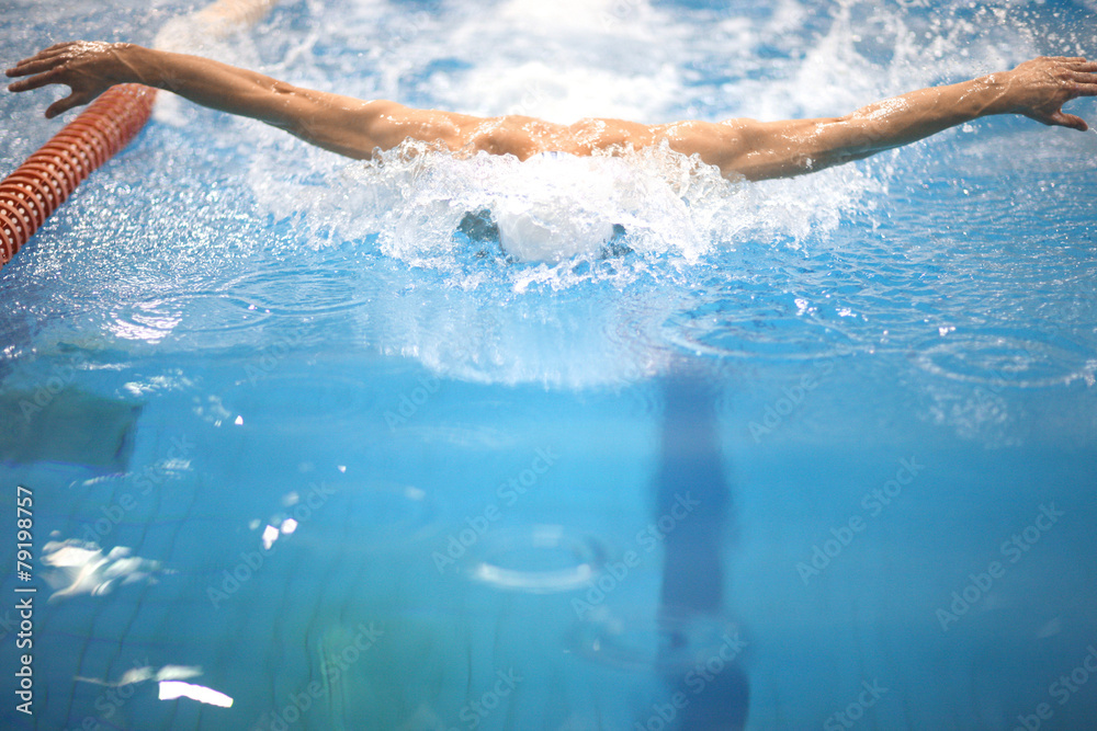 Sportsman swimming butterfly stroke