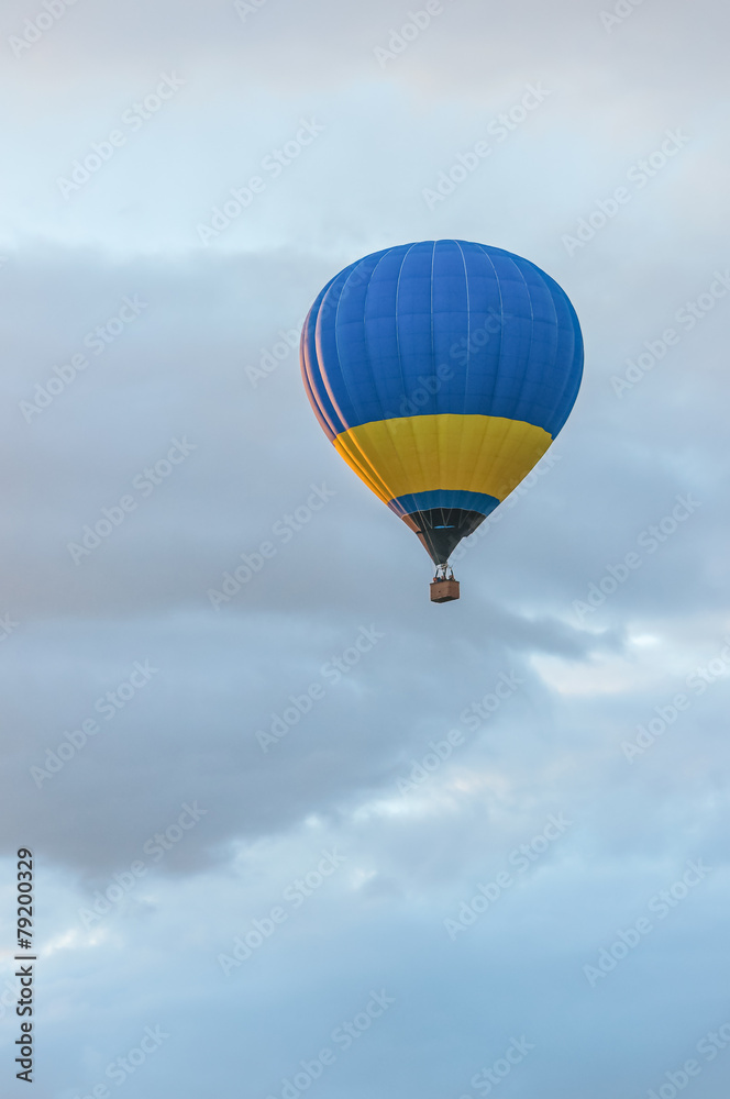 Fototapeta premium Niebieskie i żółte balony na ogrzane powietrze w locie. Na zewnątrz, kolorowe