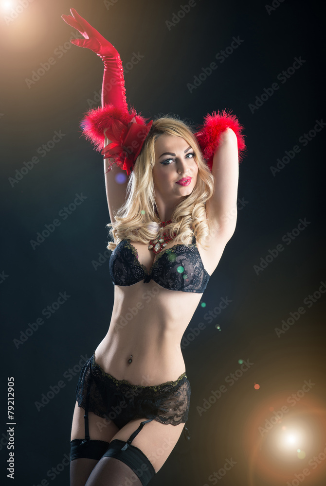 Portrait of a busty woman in vintage black bra and red gloves. S