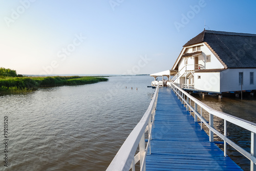 Haus am See mit blauem Steg