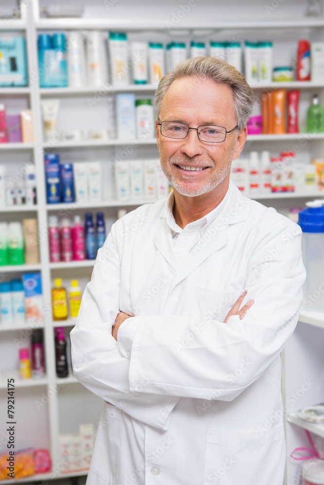 Senior pharmacist smiling at camera Senior pharmacist smiling at camera