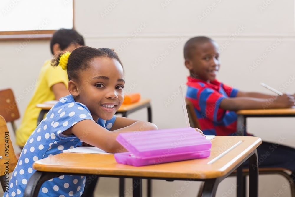 Smiling pupils sitting at her desk Smiling pupils sitting at her desk
