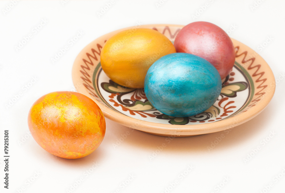 painted eggs for Easter, in plate isolated on white painted eggs for Easter, in plate isolated on white