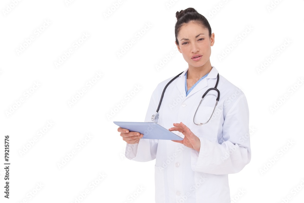 Focused doctor using her tablet pc Focused doctor using her tablet pc