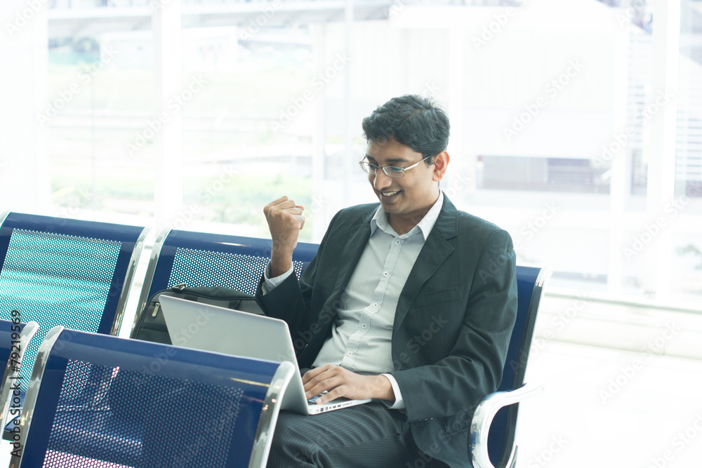 Asian Indian business man waiting his flight at airport, sitting Asian Indian business man waiting his flight at airport, sitting