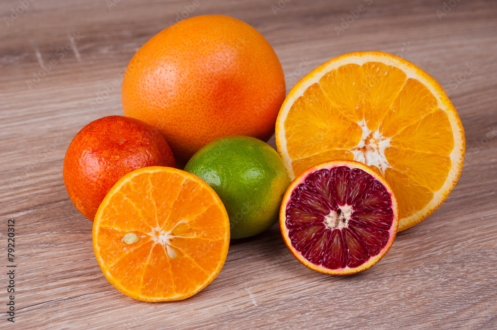 different citrus fruits on wooden background different citrus fruits on wooden background