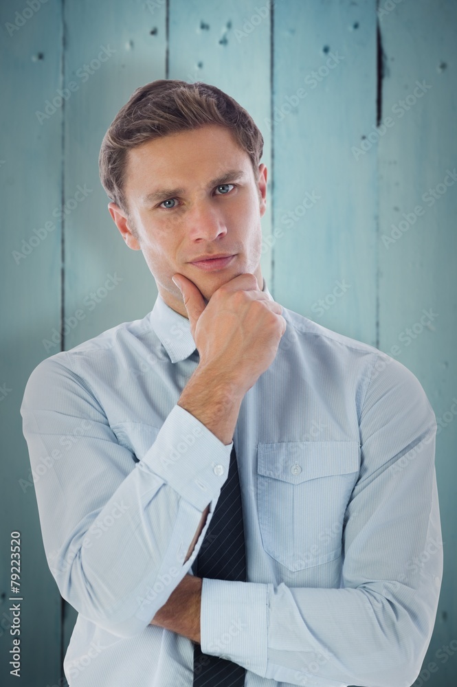 Composite image of thinking businessman with hand on chin