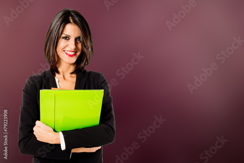 smiling professional woman on wine-colored background