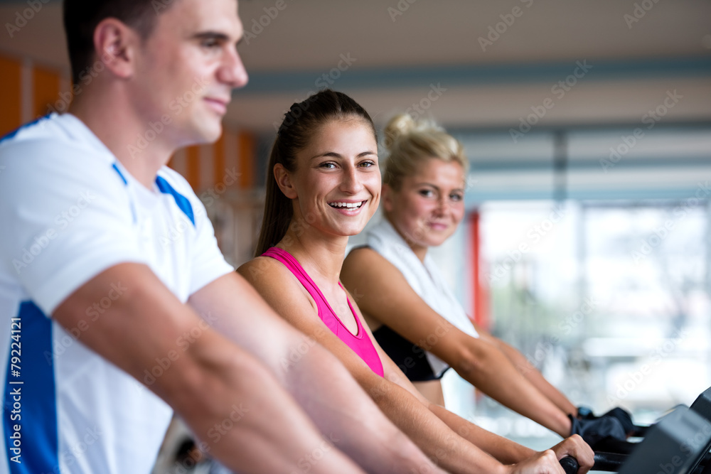 friends exercising on a treadmill at the bright modern gym friends exercising on a treadmill at the bright modern gym