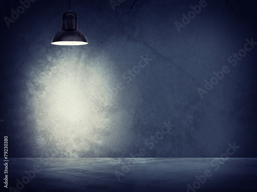 Concrete gray wall and lamp with directional light