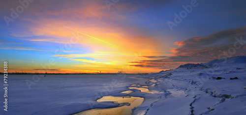 Sunset on the winter river photo