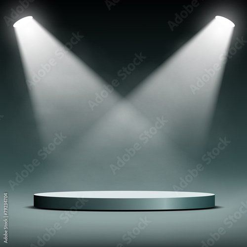 two spotlights illuminate the podium for the presentation