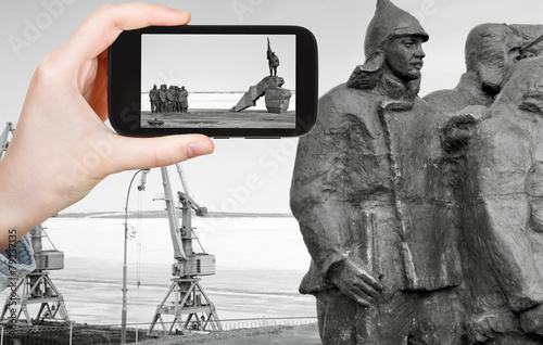 tourist taking photo of Memorial in Anadyr town photo