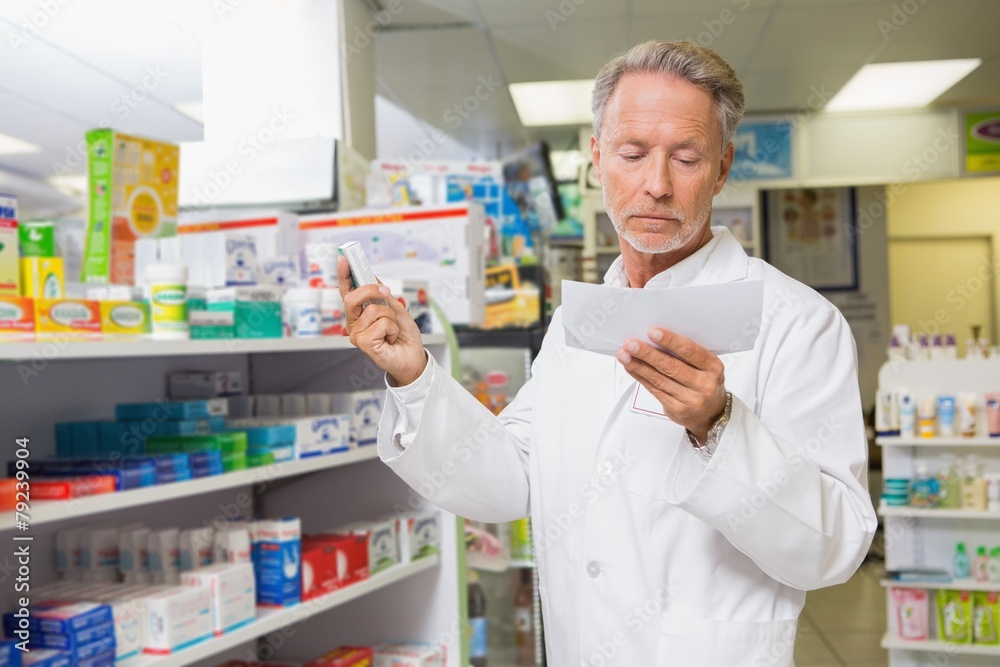 Concentrated pharmacist reading prescription