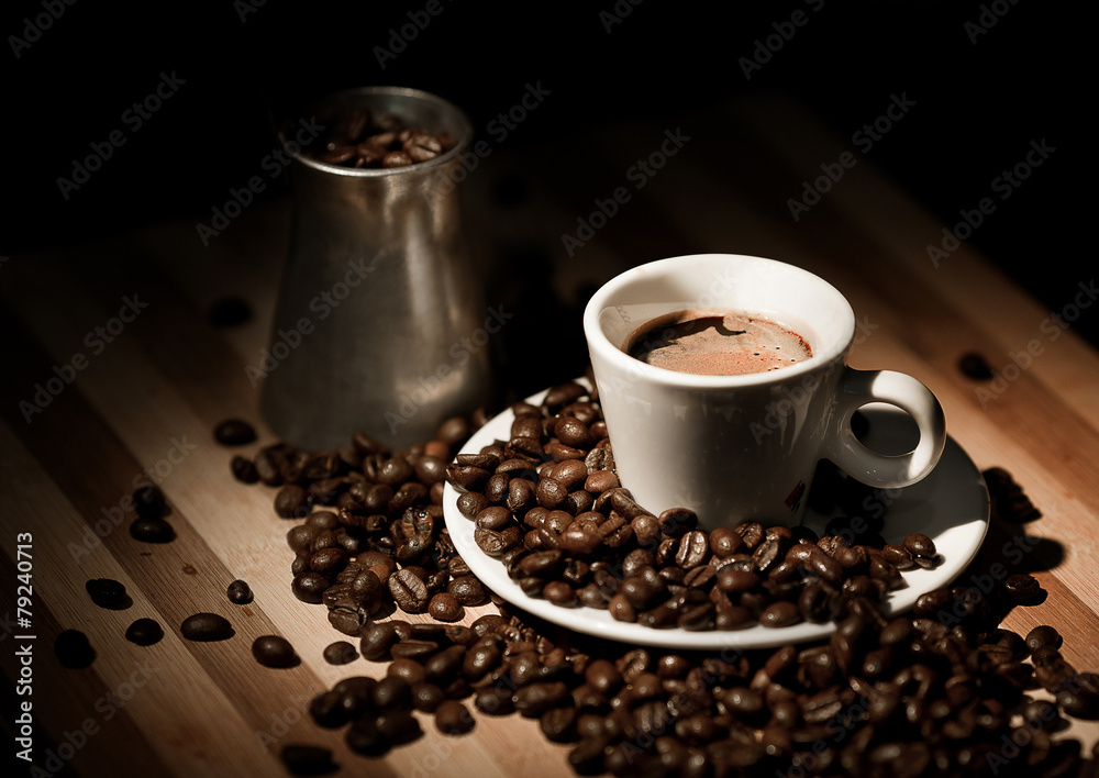 Coffee cup and coffee beans on old wooden background