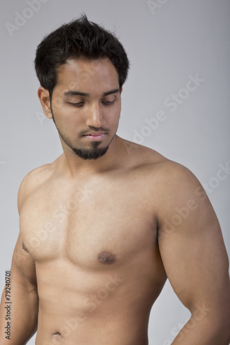 Young and fit male model showing his muscles