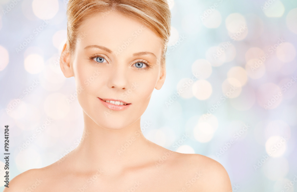 Naklejka premium beautiful young woman face over blue background