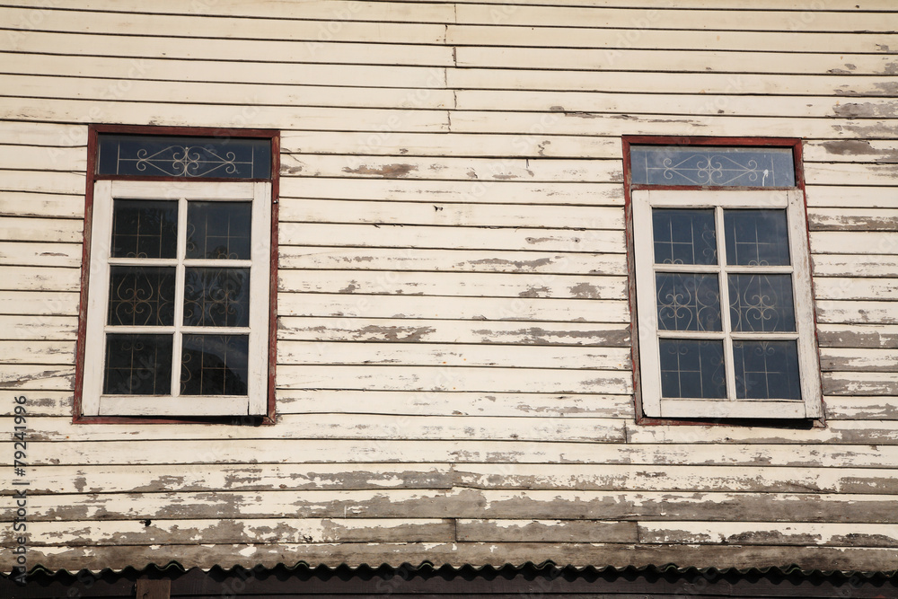 Windows and old wooden wall of cottage