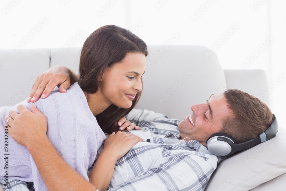 Fototapeta premium Couple looking at each other on sofa