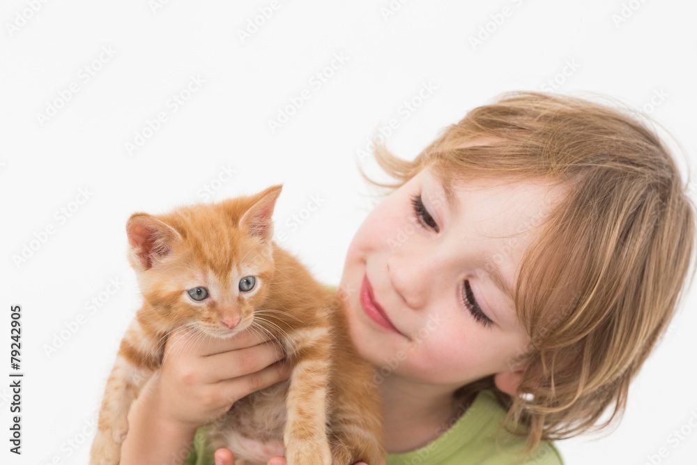 Cute boy holding while looking at kitten