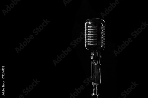 Vintage retro microphone isolated on black background