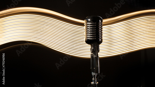 Photography Vintage retro microphone on the black background with light wave