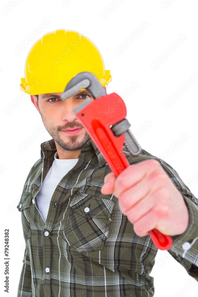 Manual worker looking through monkey wrench Manual worker looking through monkey wrench