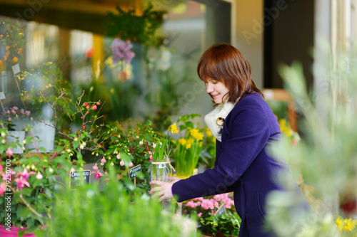 Beautiful woman selecting flowers at flower market