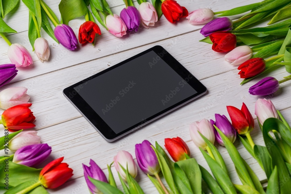 Tulips forming frame around tablet Tulips forming frame around tablet