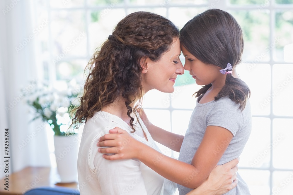 Happy mother and daughter embracing