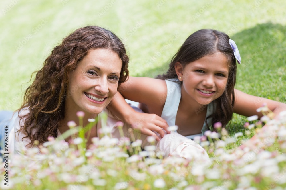 Happy mother and daughter lying on the grass Happy mother and daughter lying on the grass