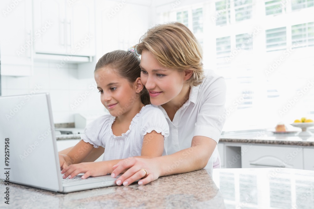 Mother and daughter using laptop Mother and daughter using laptop