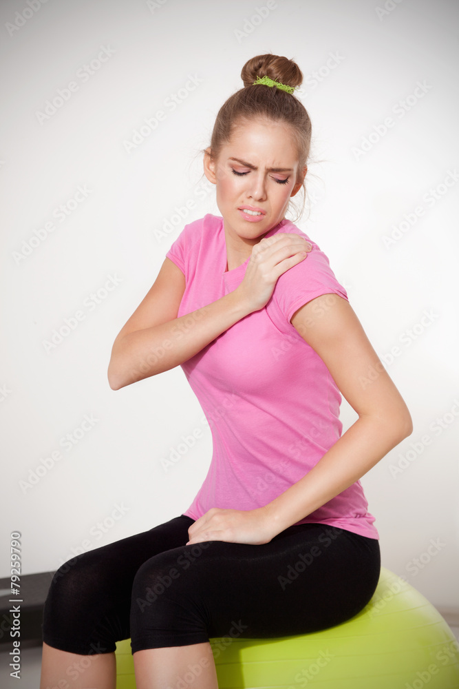 Woman with shoulder pain during workout Woman with shoulder pain during workout