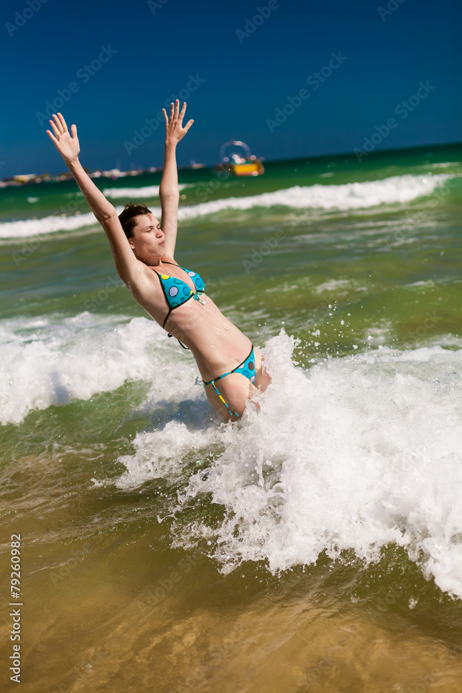 woman splashing water in the ocean