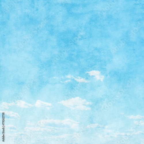 Grunge image of blue sky with white clouds.