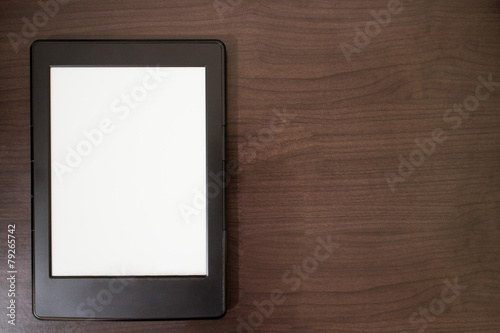 E-book reader on wooden table background with copy space