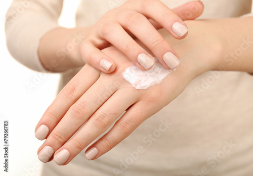 Female applying cream on her hand  closeup