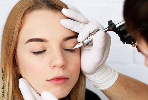 Cosmetologist making perman...