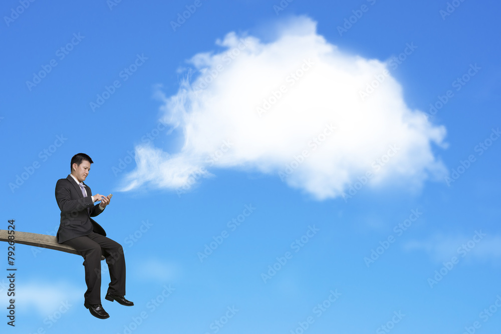 Using mobile businessman on springboard with white thought bubbl Using mobile businessman on springboard with white thought bubbl