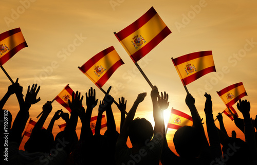 Silhouettes of People Holding Flag of Spain Concept