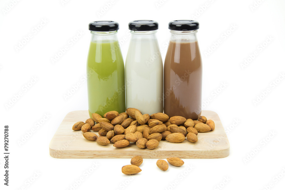 Almond milk in glass bottles with almonds Almond milk in glass bottles with almonds