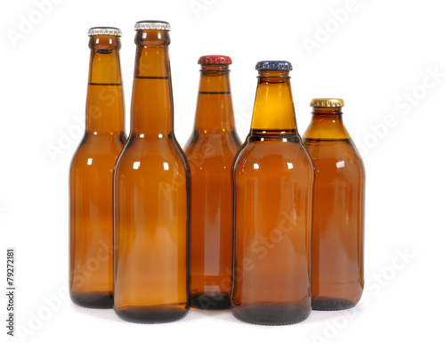 Row or line of several different size shape brown beer bottles isolated on white background photo
