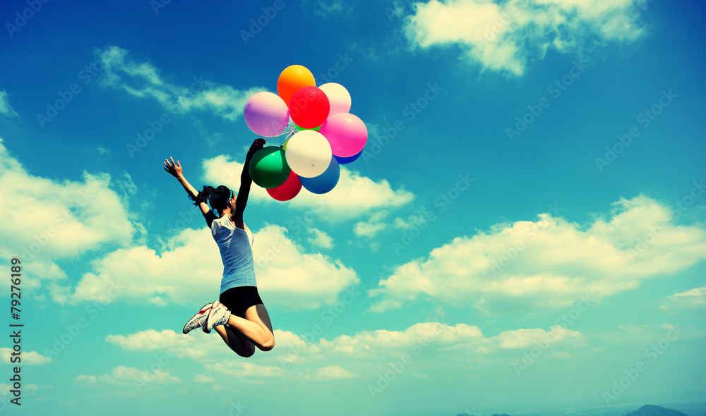 young asian woman jumping with colored balloons young asian woman jumping with colored balloons